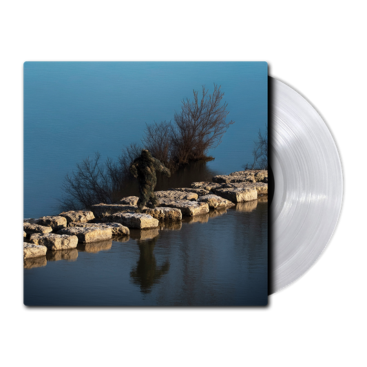 Vinyl Record with a nature-themed design of a Sasquatch waking on rocks in between a lake on a blue background with a silver vinyl coming out of the packet.